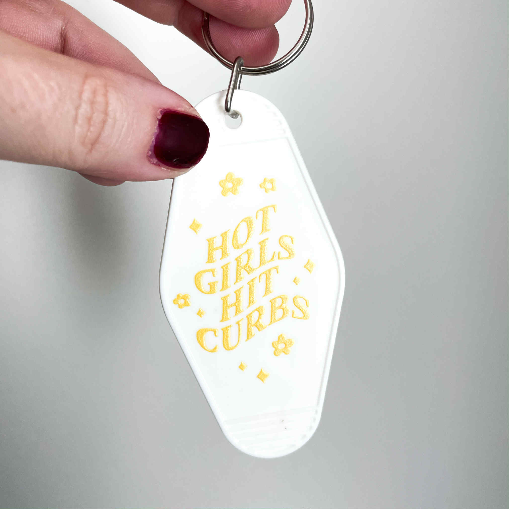 HOT GIRLS HIT CURBS MOTEL KEYCHAIN (WHITE)